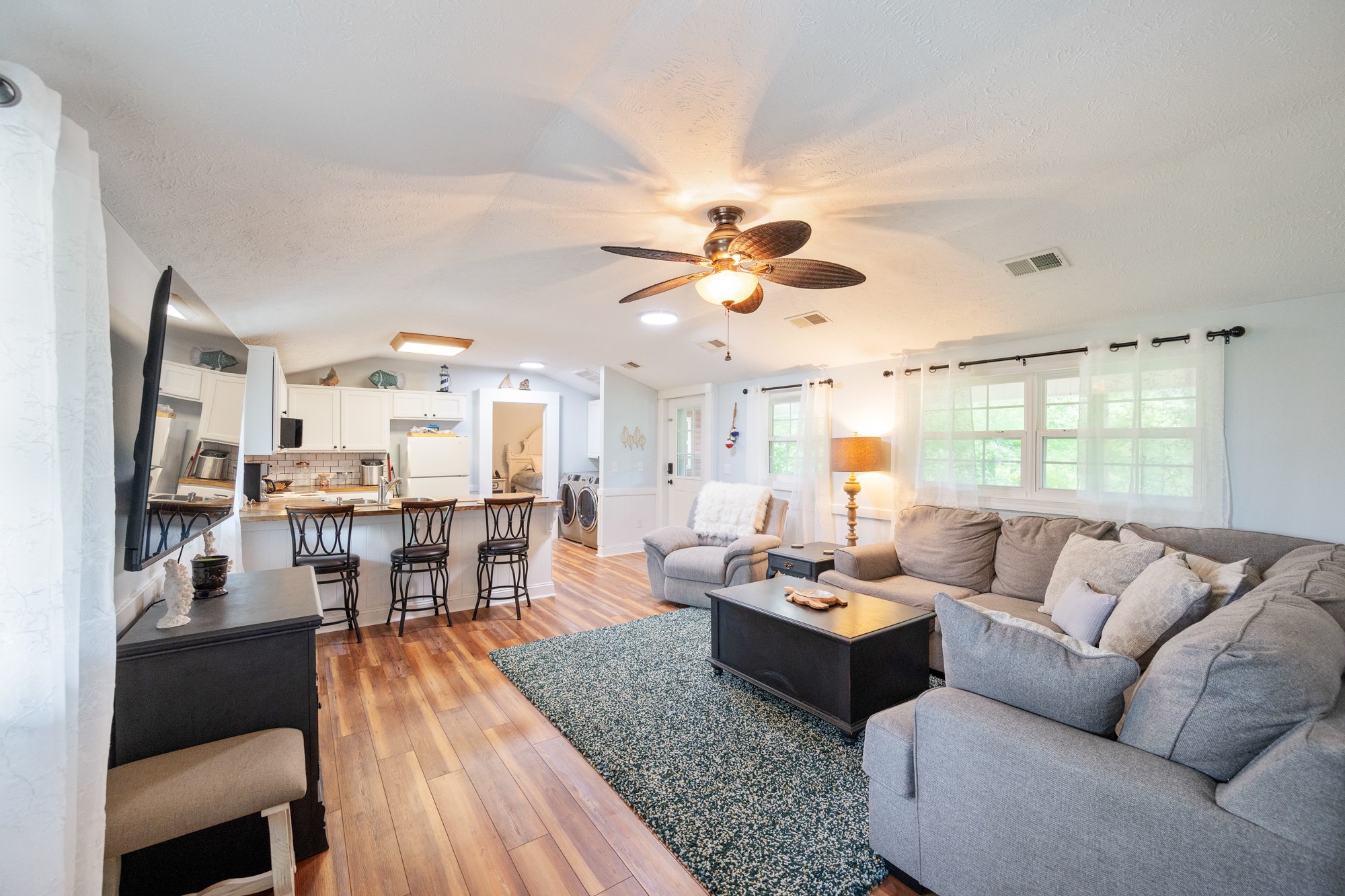 91 Creekside View Lane Decaturville, TN 38329 - Photo 16 of 57 a living room with furniture kitchen view and a large window