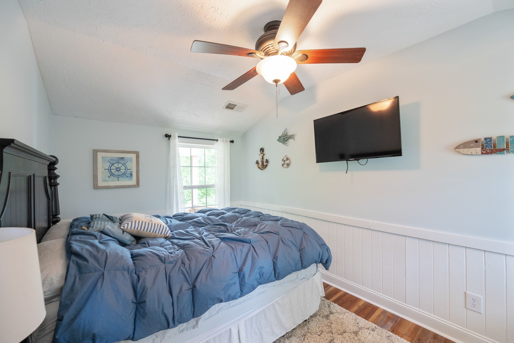 91 Creekside View Lane Decaturville, TN 38329 - Photo 17 of 57 a bedroom with a large bed and a flat screen tv