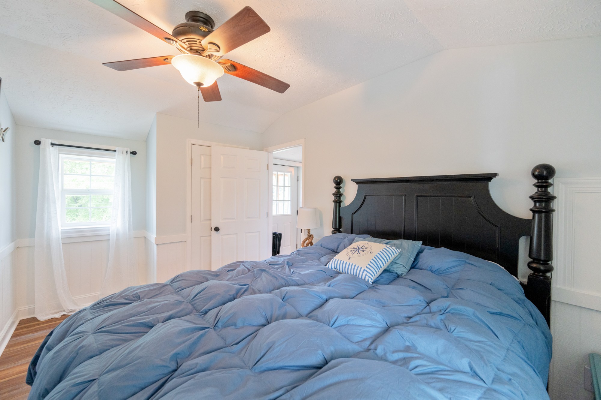 91 Creekside View Lane Decaturville, TN 38329 - Photo 18 of 57 a bedroom with a bed and a chandelier