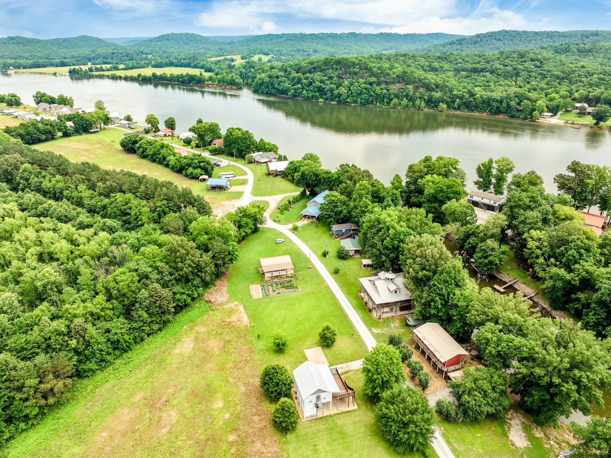 91 Creekside View Lane Decaturville, TN 38329 - Photo 28 of 57 an aerial view of residential houses with outdoor space and lake view
