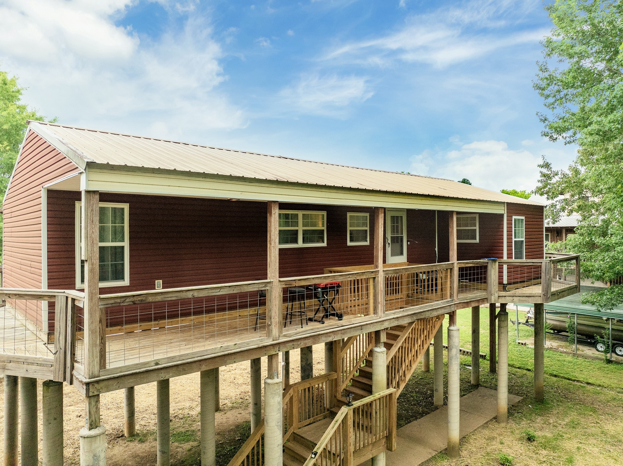 91 Creekside View Lane Decaturville, TN 38329 - Photo 38 of 57 a view of a house with large windows and plants
