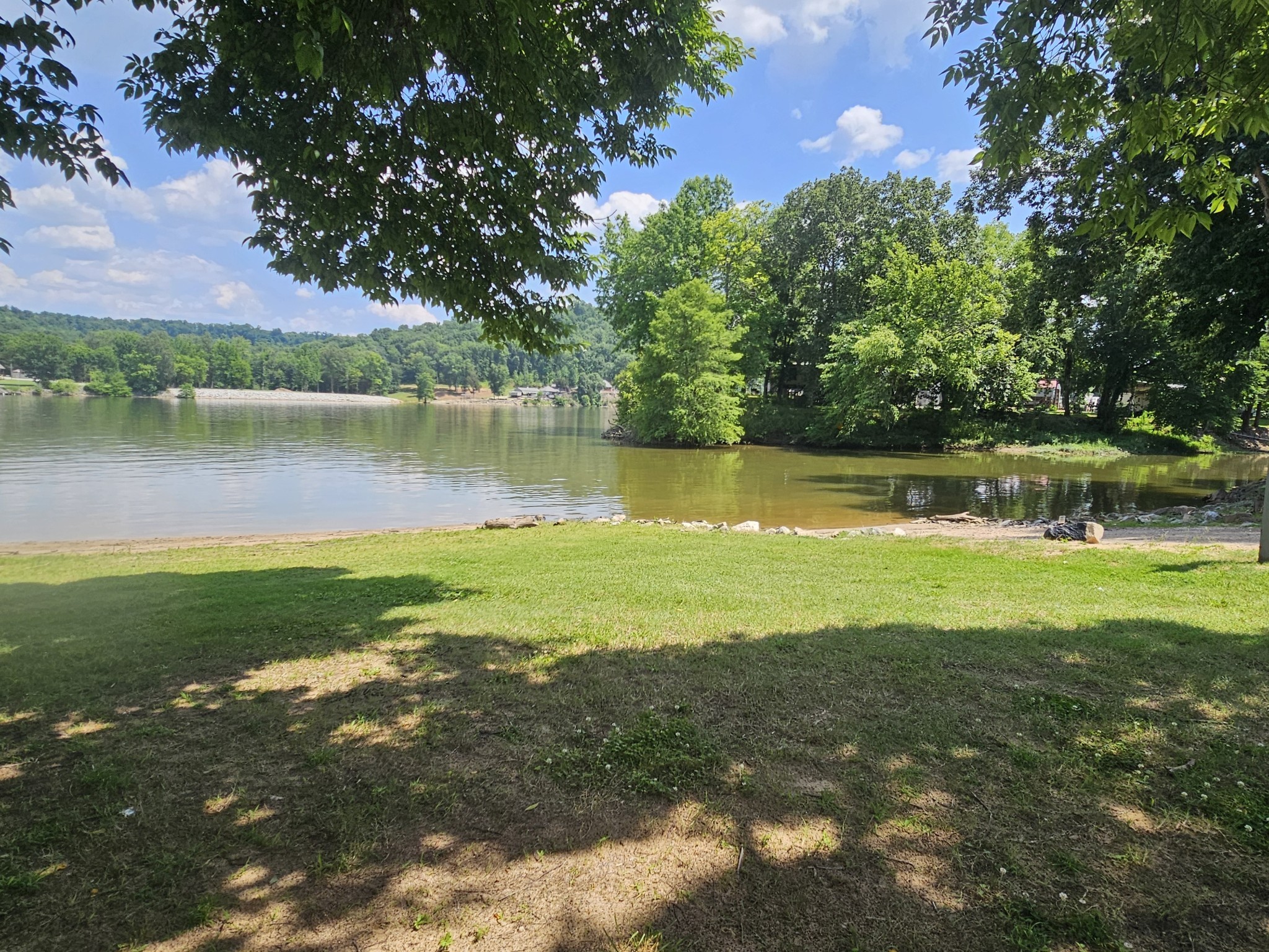 91 Creekside View Lane Decaturville, TN 38329 - Photo 55 of 57 a view of a lake with houses in the back