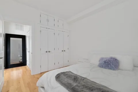 a bedroom with a bed and pillows