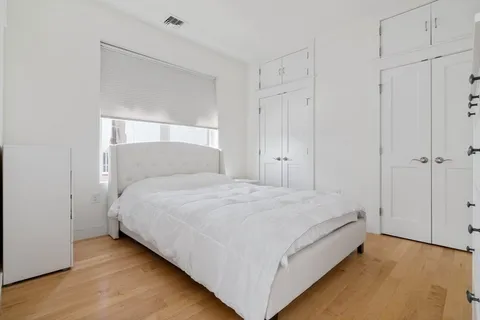 a bedroom with a bed and a mirror