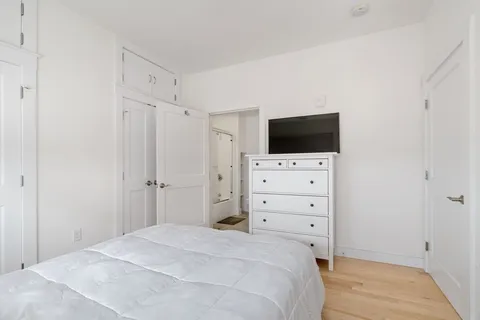 a room with a bed and a flat screen tv