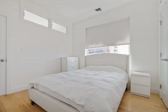 a bedroom with a bed and a night stand