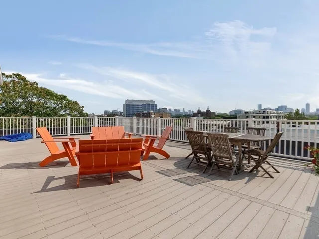 an outdoor sitting area with furniture and wooden floor