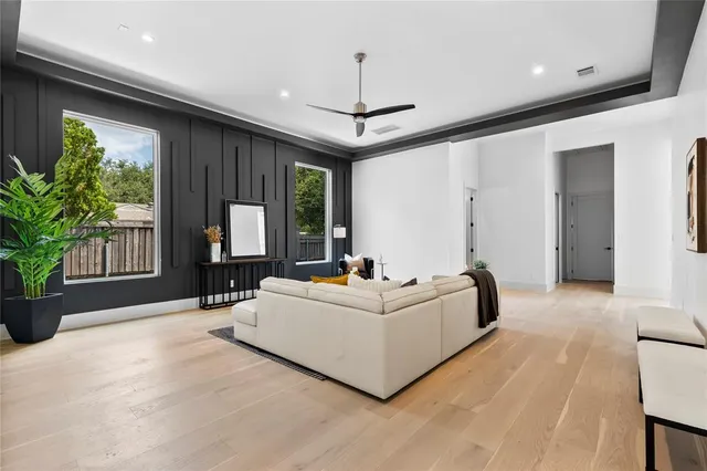 a living room with furniture and a floor to ceiling window