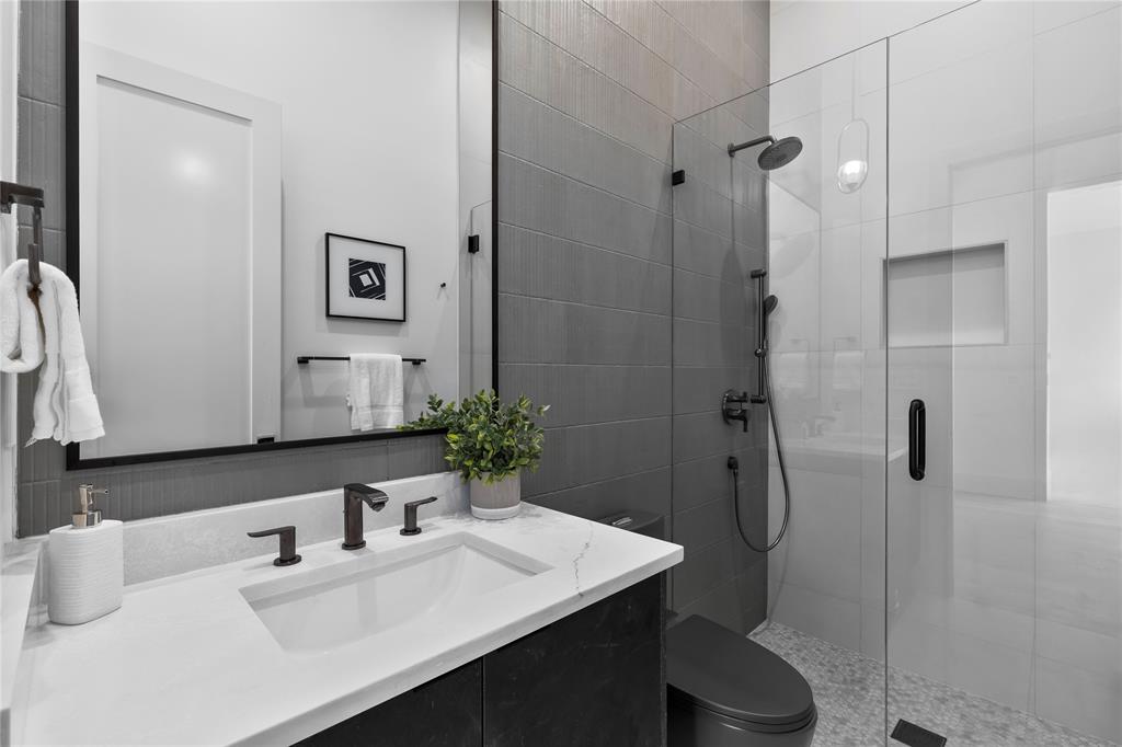 11232 Hillcrest Road Dallas, TX 75230 - Photo 16 of 40 a bathroom with a sink toilet and shower