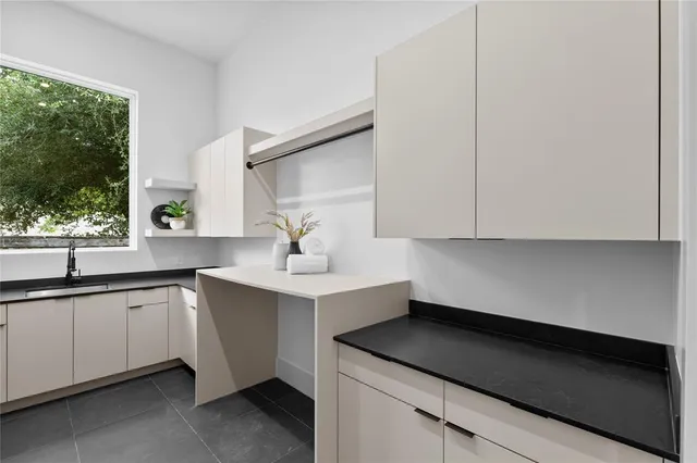 a kitchen with granite countertop a sink and a window