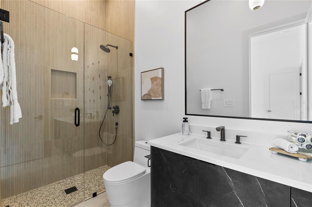 11232 Hillcrest Road Dallas, TX 75230 - Photo 28 of 40 a bathroom with a sink a toilet and shower