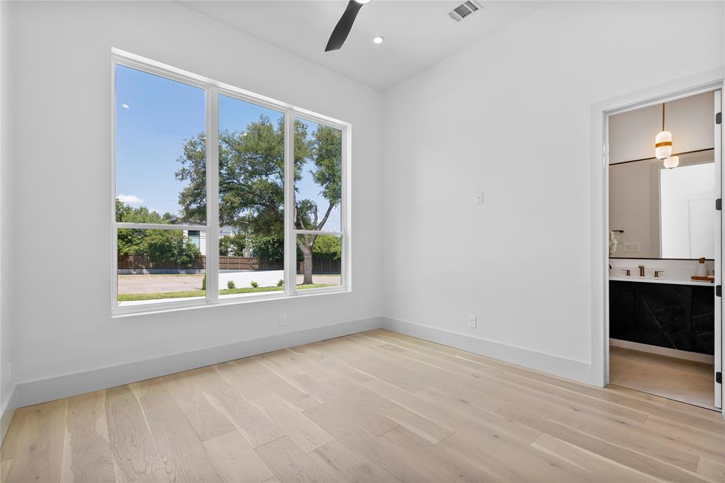 11232 Hillcrest Road Dallas, TX 75230 - Photo 29 of 40 an empty room with wooden floor and a window