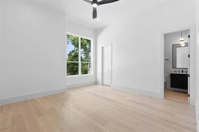 an empty room with windows and cabinet