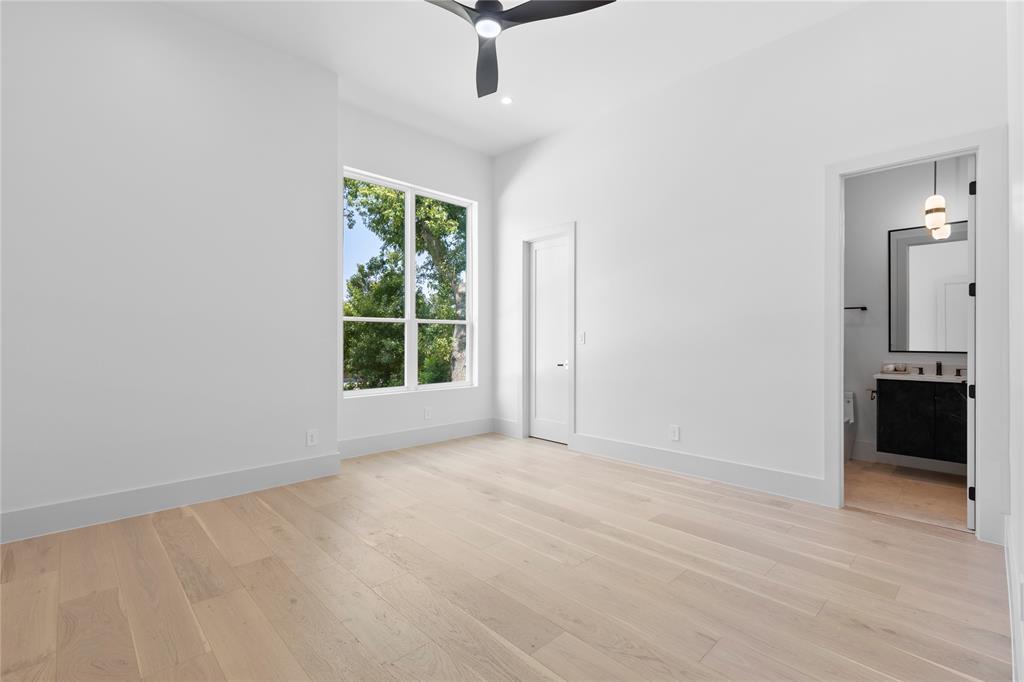 11232 Hillcrest Road Dallas, TX 75230 - Photo 31 of 40 an empty room with windows and cabinet