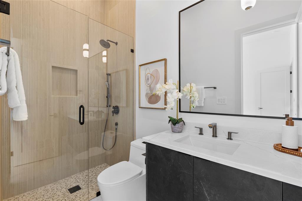 11232 Hillcrest Road Dallas, TX 75230 - Photo 32 of 40 a bathroom with a sink a toilet and shower