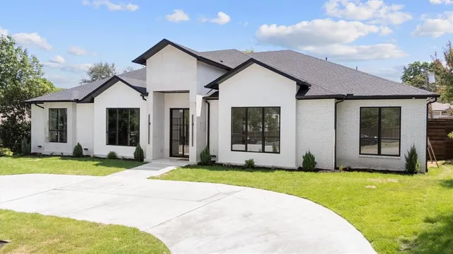 a front view of a house with a yard and porch