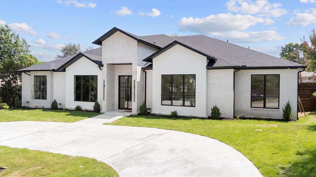 11232 Hillcrest Road Dallas, TX 75230 - Photo 35 of 40 a front view of a house with a yard and porch