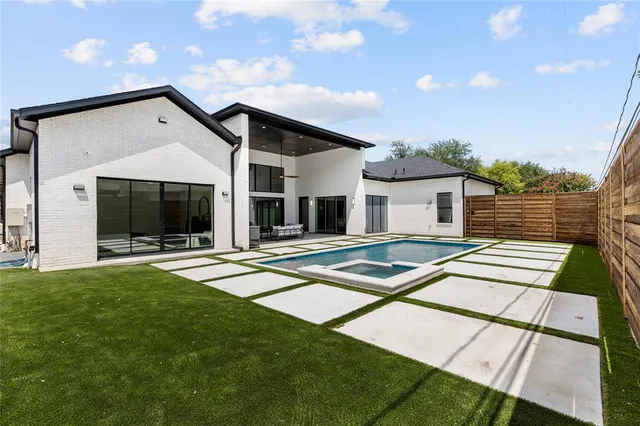 a view of a house with backyard and porch