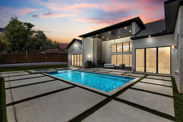 a view of a house with swimming pool and sitting area