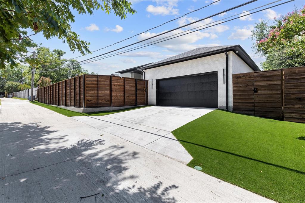 11232 Hillcrest Road Dallas, TX 75230 - Photo 39 of 40 a front view of a house with a garden