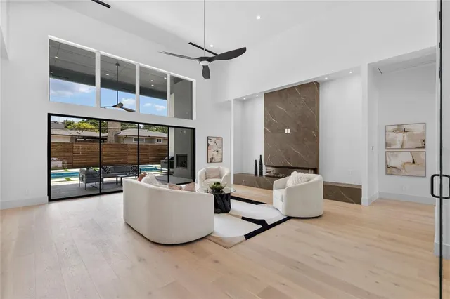 a living room with furniture and a floor to ceiling window