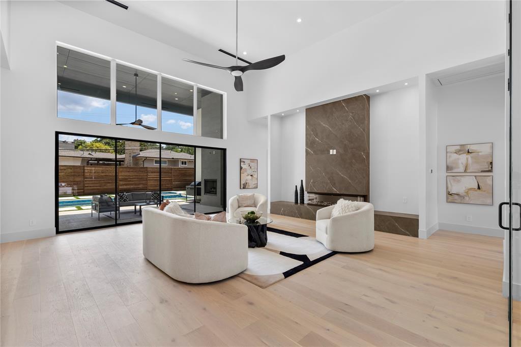 11232 Hillcrest Road Dallas, TX 75230 - Photo 4 of 40 a living room with furniture and a floor to ceiling window