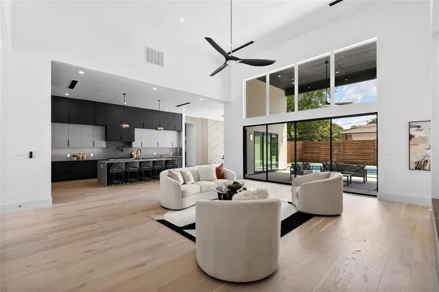 a living room with furniture and kitchen view