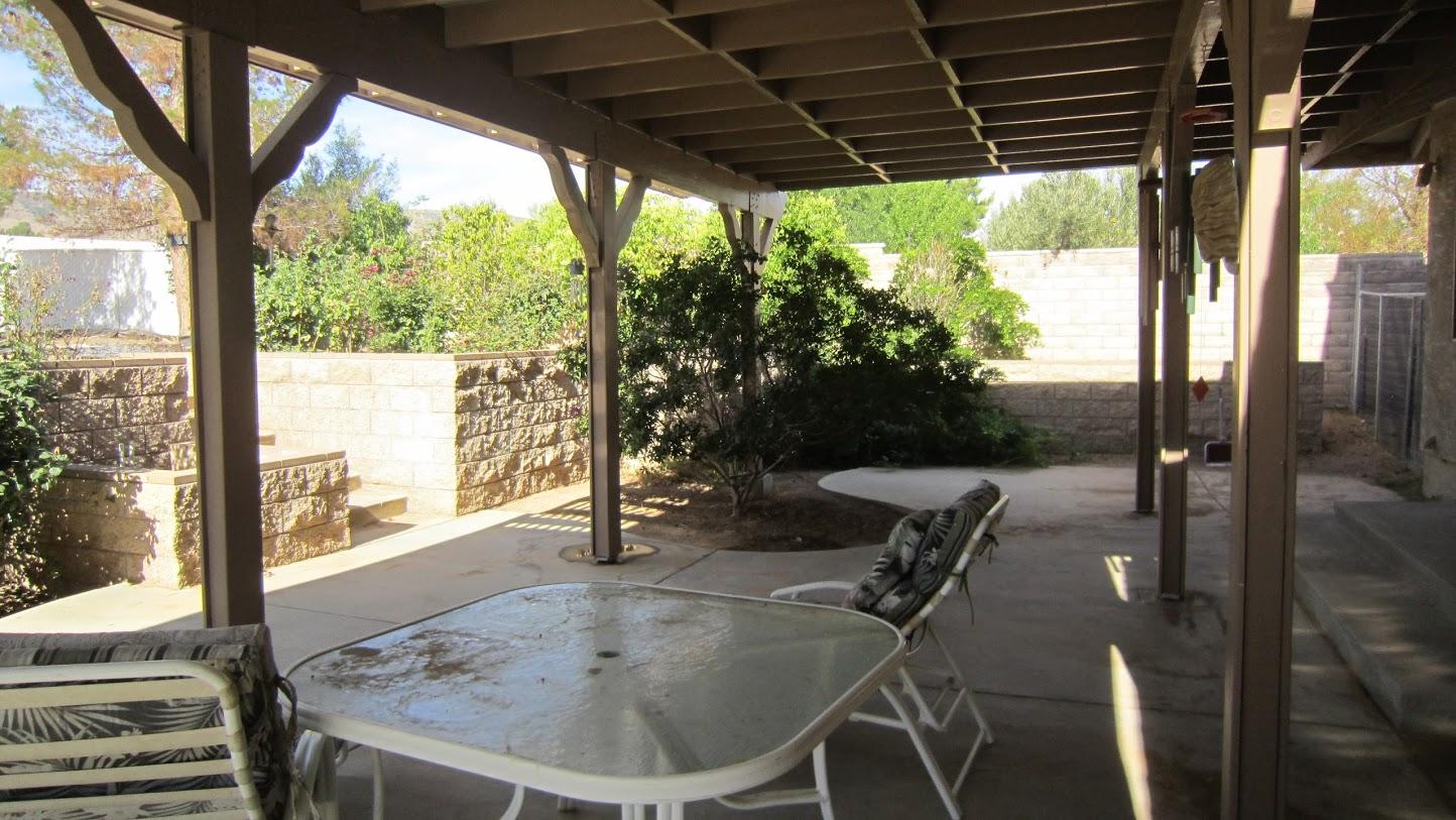 5616 West Ave M-4 Lancaster, CA 93536 - Photo 12 of 12 a view of a porch with furniture and yard