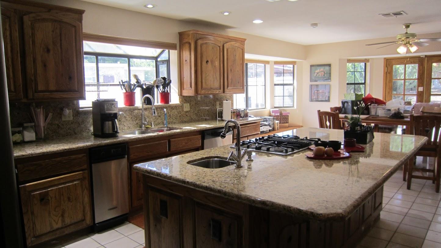 5616 West Ave M-4 Lancaster, CA 93536 - Photo 5 of 12 a kitchen with sink a window and chairs