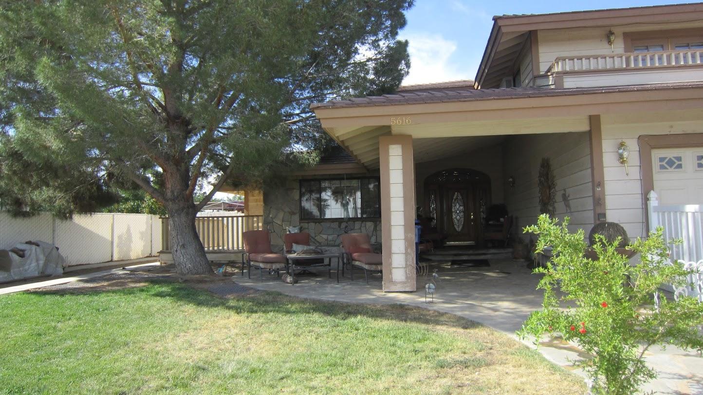 5616 West Ave M-4 Lancaster, CA 93536 - Photo 10 of 12 a view of a house with backyard porch and sitting area