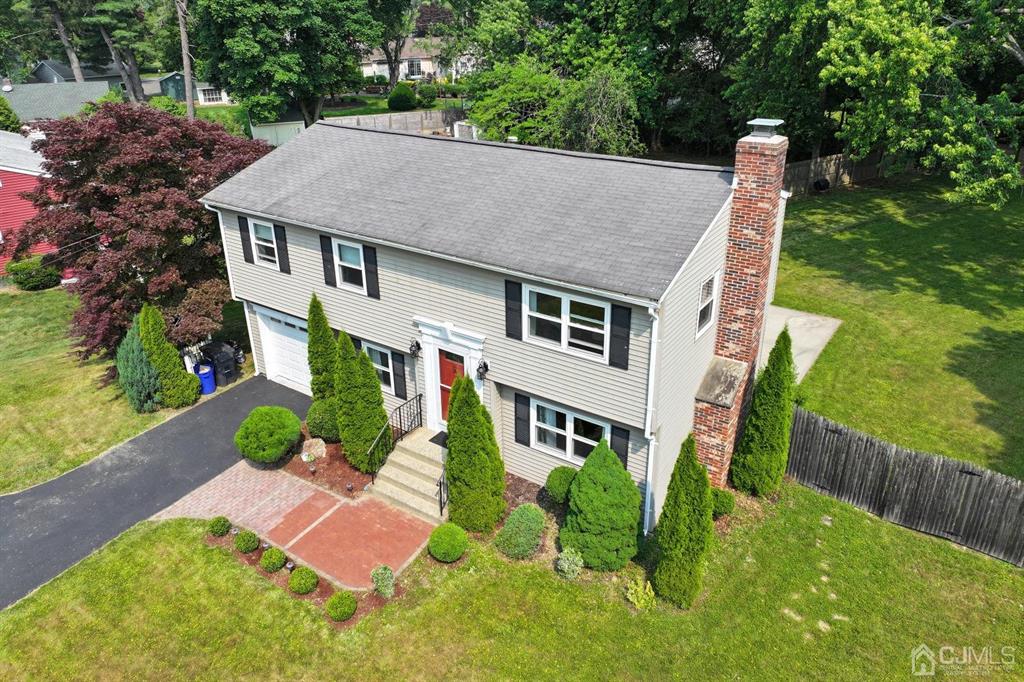 a aerial view of a house with swimming pool garden and patio