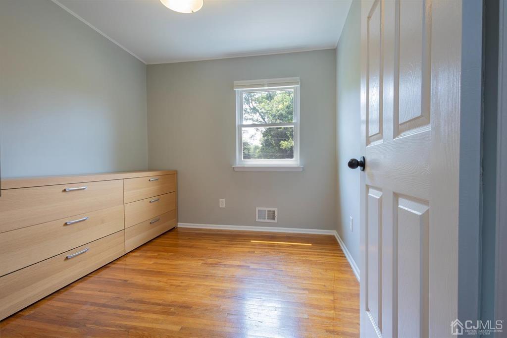 53 Edgemere Avenue Plainsboro, NJ 08536 - Photo 14 of 39 a view of an empty room with wooden floor and a window