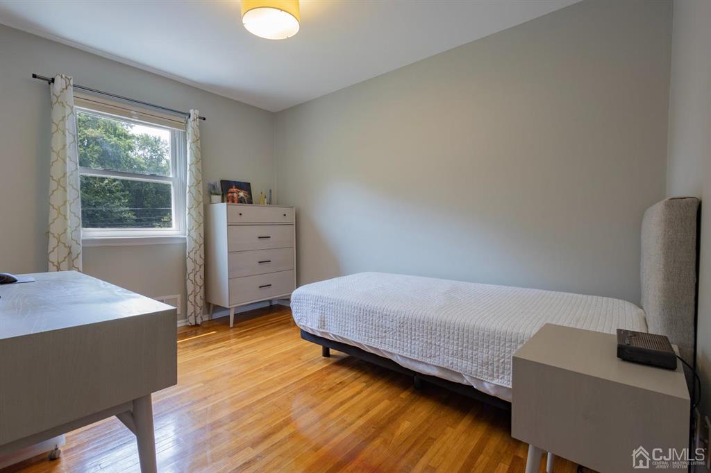 53 Edgemere Avenue Plainsboro, NJ 08536 - Photo 15 of 39 a bedroom with a bed and wooden floor