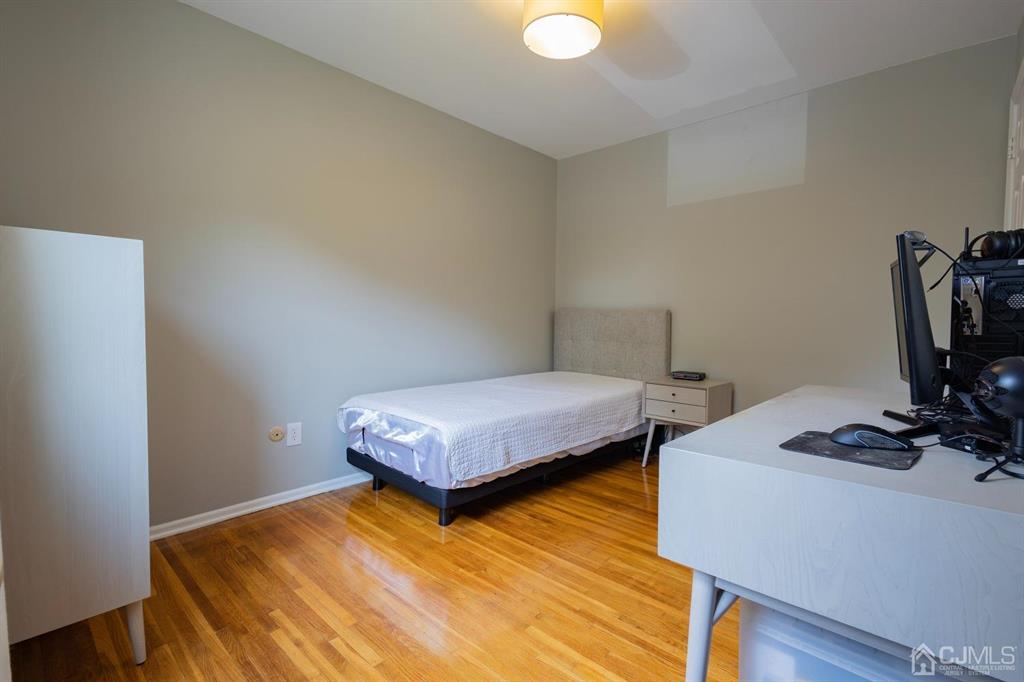 53 Edgemere Avenue Plainsboro, NJ 08536 - Photo 16 of 39 a bedroom with bed and a flat tv screen on a dresser