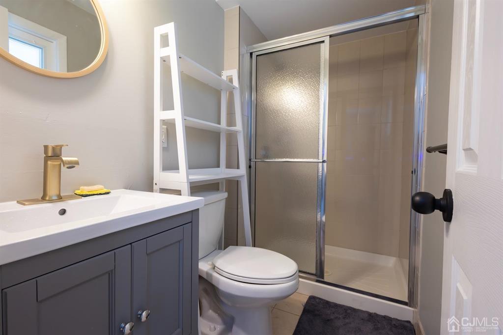 53 Edgemere Avenue Plainsboro, NJ 08536 - Photo 29 of 39 a bathroom with a sink a toilet and shower