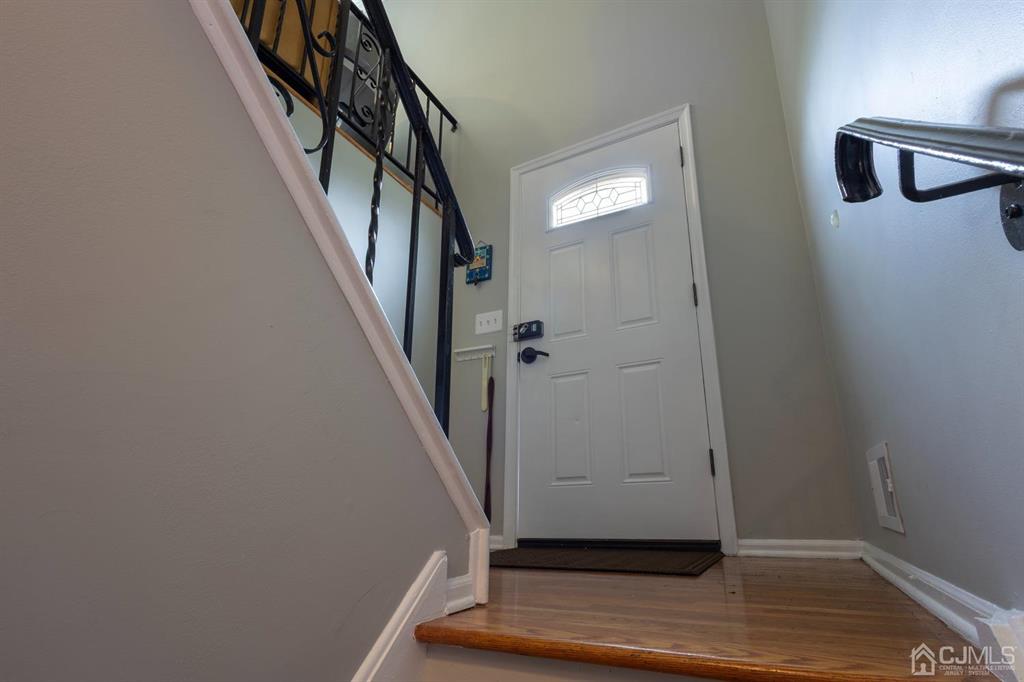 53 Edgemere Avenue Plainsboro, NJ 08536 - Photo 30 of 39 a view of a hallway with wooden floor and staircase