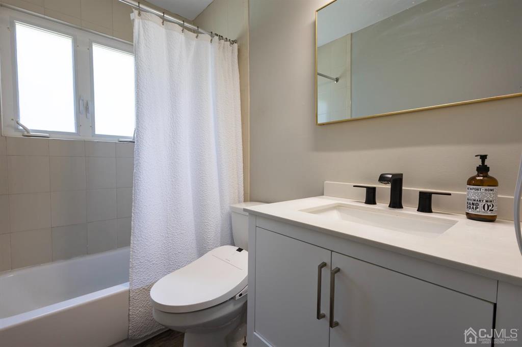 53 Edgemere Avenue Plainsboro, NJ 08536 - Photo 10 of 39 a bathroom with a sink a toilet and shower