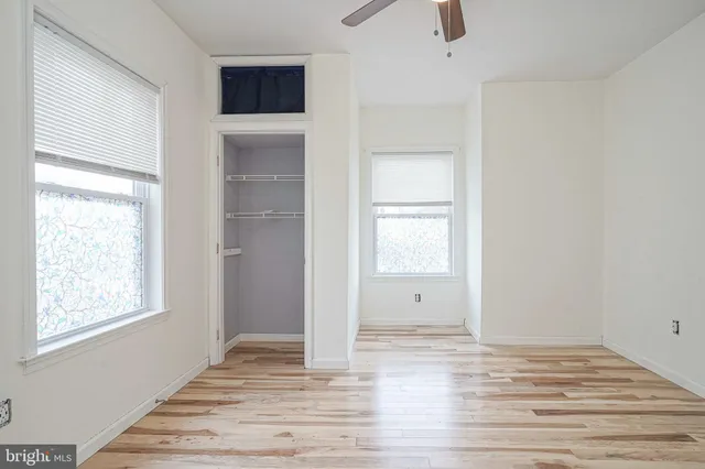 a view of a livingroom with wooden floor and window