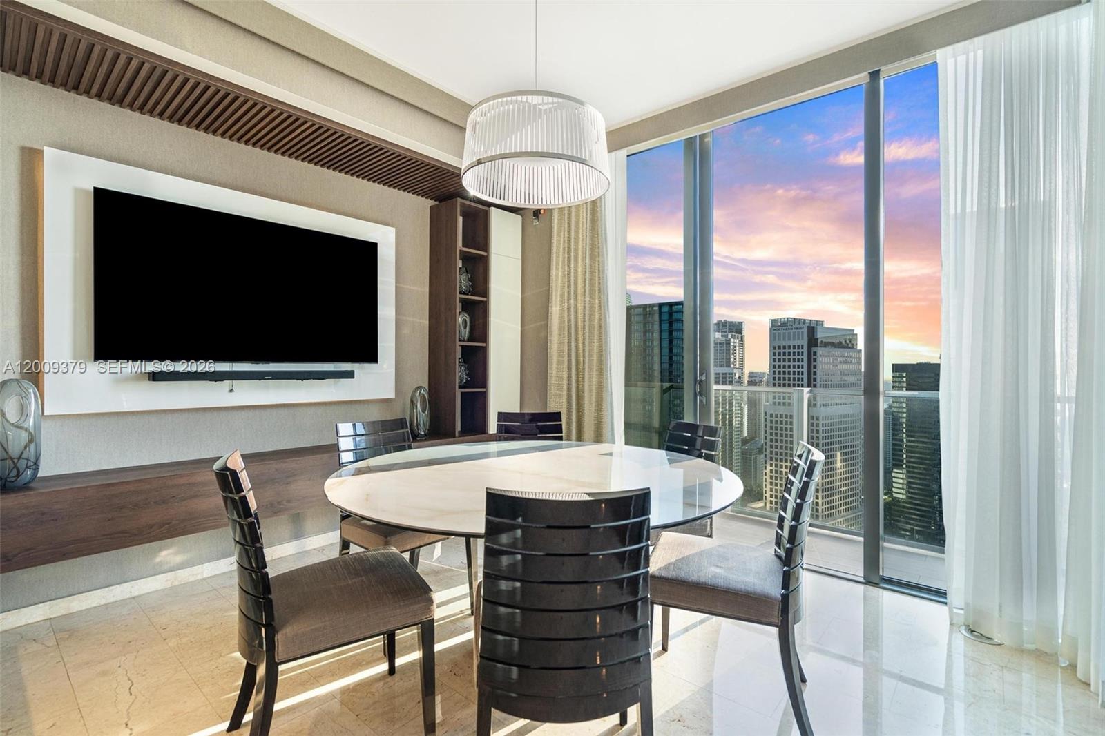 88 Southwest 7th Street, Unit 3801 Miami, FL 33130 - Photo 16 of 87 a view of a dining room with furniture wooden floor and chandelier