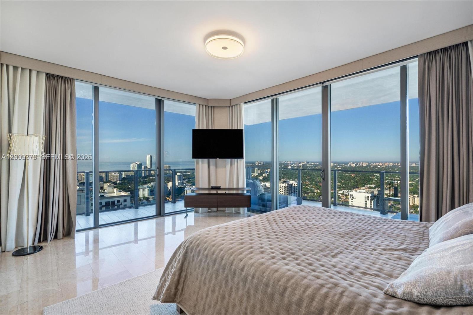 88 Southwest 7th Street, Unit 3801 Miami, FL 33130 - Photo 23 of 87 a bedroom with a large bed and a large window