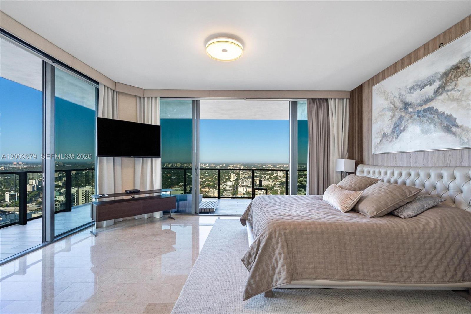 88 Southwest 7th Street, Unit 3801 Miami, FL 33130 - Photo 30 of 87 a bedroom with a large bed and a flat screen tv