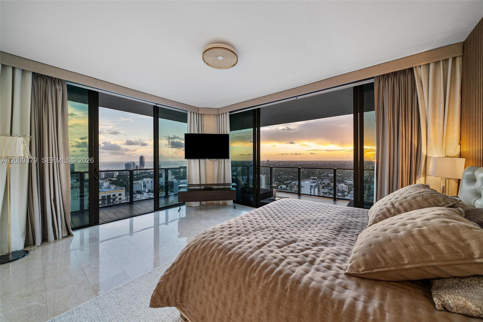 88 Southwest 7th Street, Unit 3801 Miami, FL 33130 - Photo 59 of 87 a spacious bedroom with a large bed and a large window