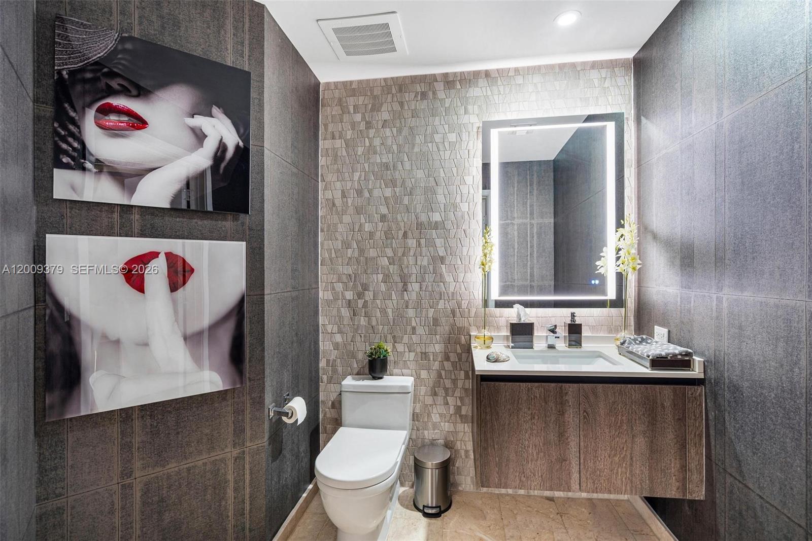 88 Southwest 7th Street, Unit 3801 Miami, FL 33130 - Photo 72 of 87 a bathroom with a toilet sink and mirror