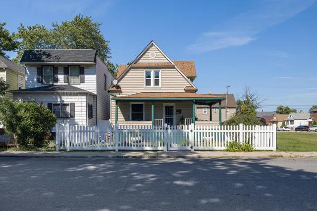 a front view of a house with a fence
