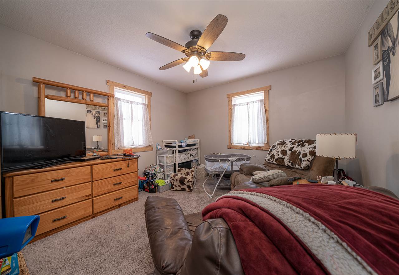 1785 Willow Road Franklin Grove, IL 61031 - Photo 17 of 38 a bedroom with a bed and a flat screen tv