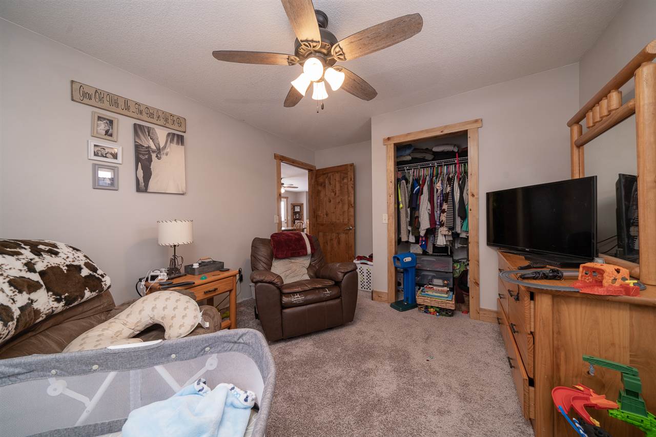 1785 Willow Road Franklin Grove, IL 61031 - Photo 18 of 38 a living room with furniture and a flat screen tv
