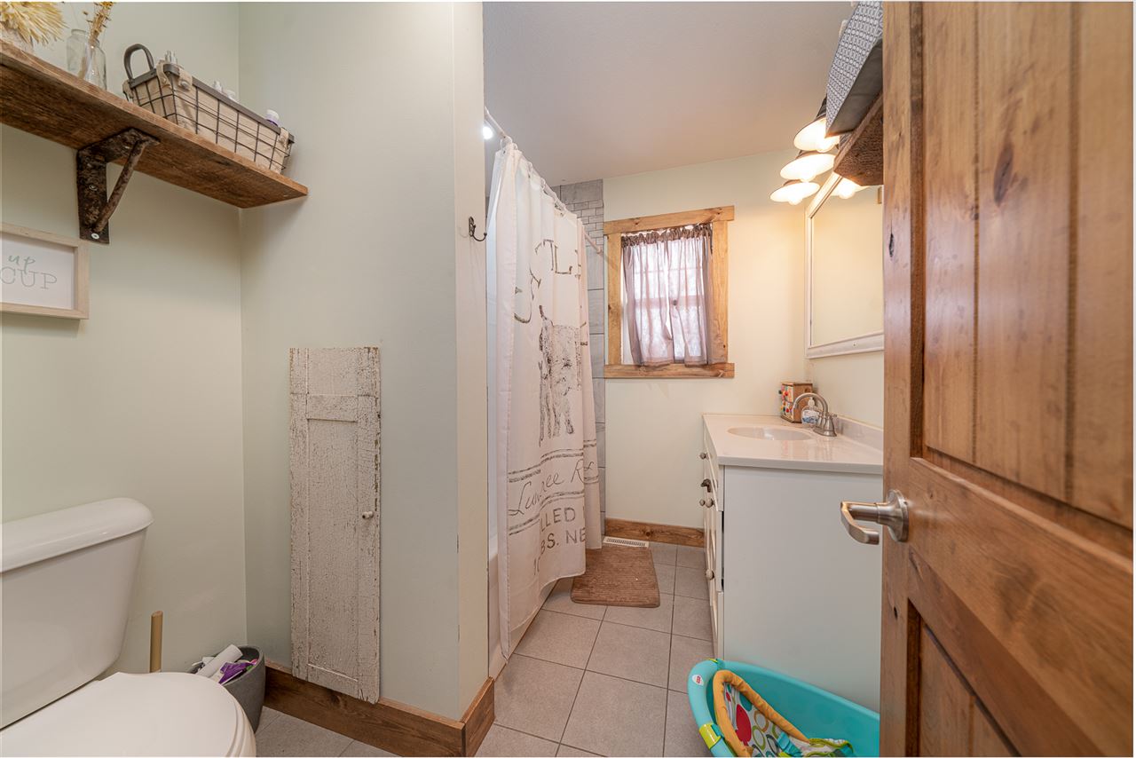 1785 Willow Road Franklin Grove, IL 61031 - Photo 19 of 38 a bathroom with a sink a toilet and shower