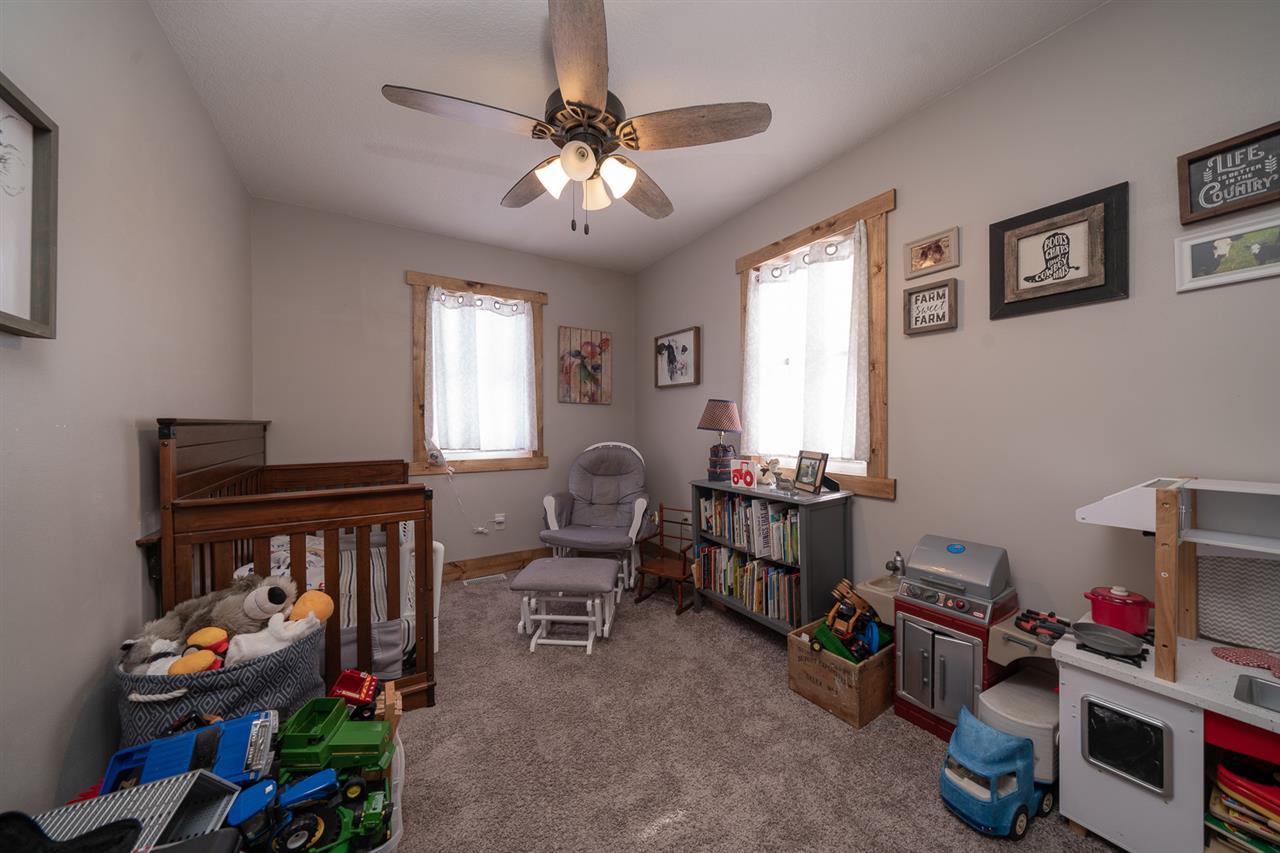 1785 Willow Road Franklin Grove, IL 61031 - Photo 20 of 38 a room with furniture a chandelier and a window