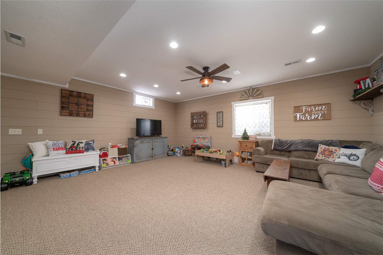 1785 Willow Road Franklin Grove, IL 61031 - Photo 25 of 38 a living room with furniture and a flat screen tv