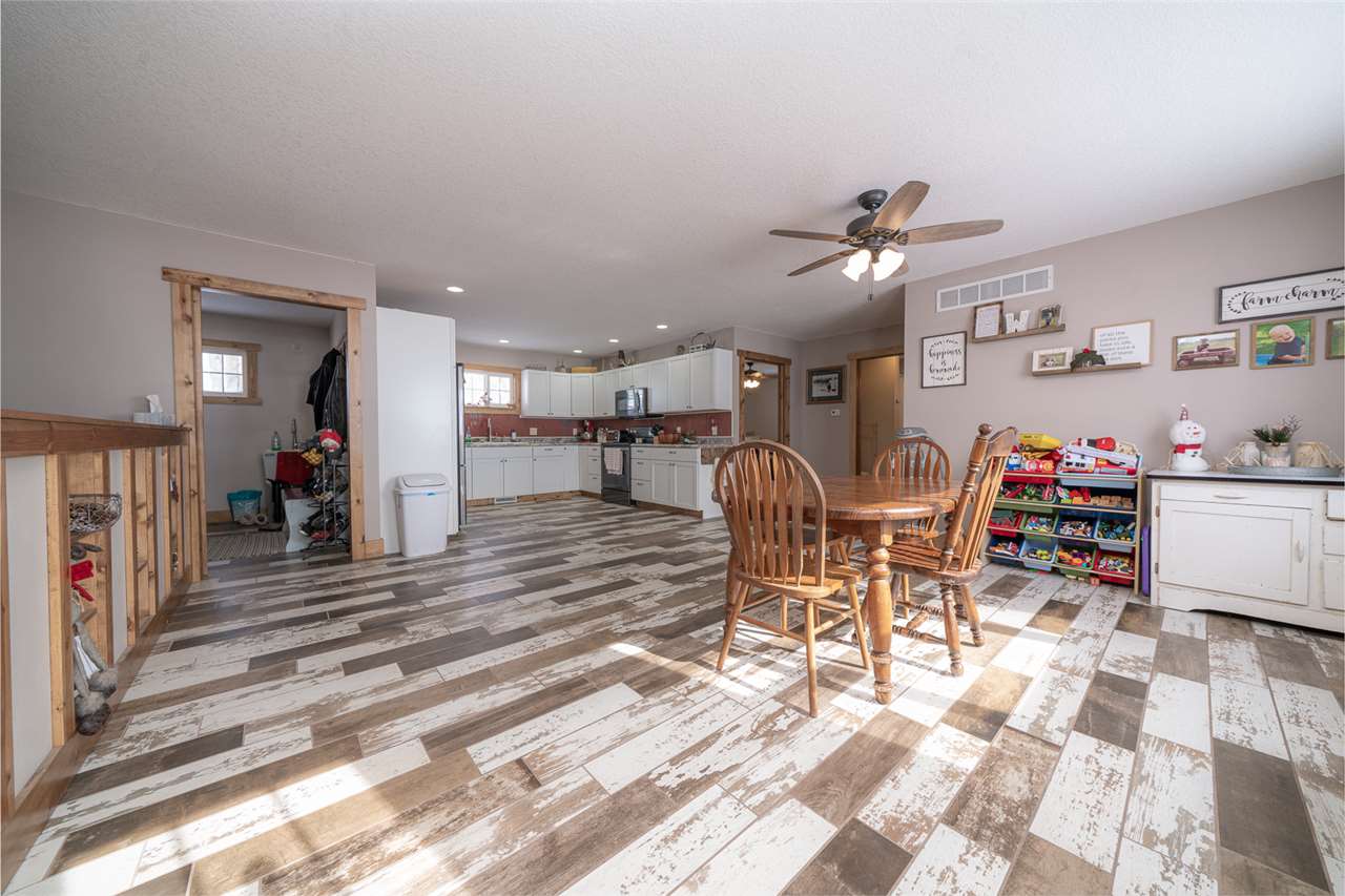 1785 Willow Road Franklin Grove, IL 61031 - Photo 36 of 38 a living room with furniture a wooden floor and a chandelier